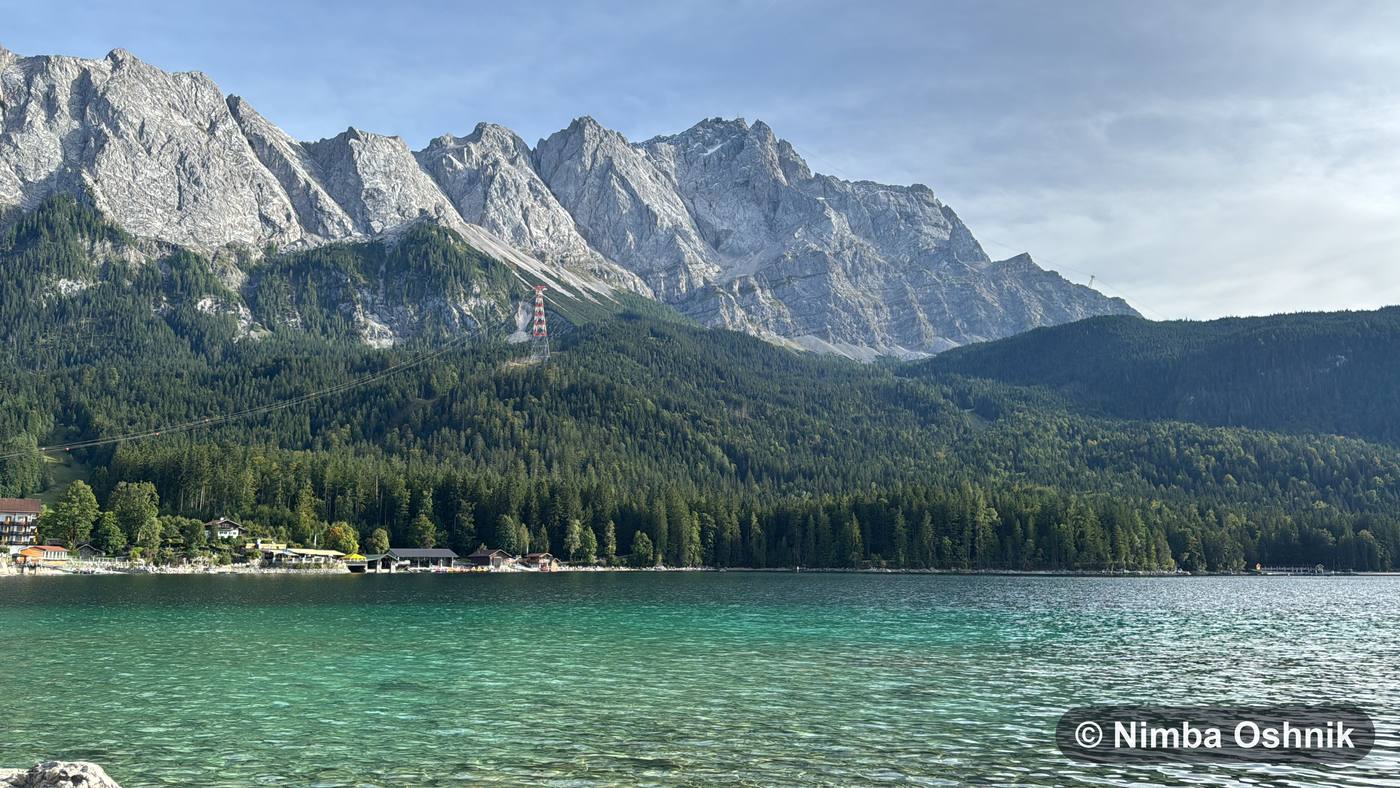 Turquoise alpine lake beneath a rugged limestone mountain range